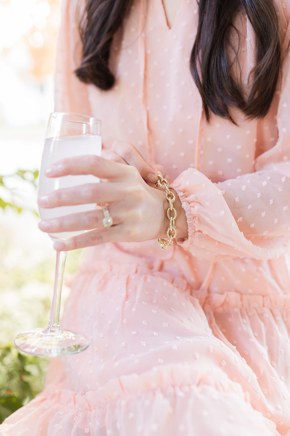 Affordable fashion blogger Stephanie Ziajka styles a gold Kendra Scott Livy bracelet with a pale pink wedding guest dress on Diary of a Debutante