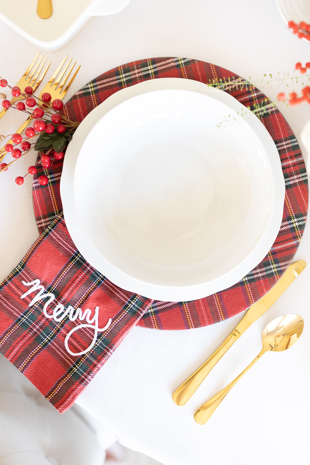 Mud Pie Christmas napkins and chargers styled in a Christmas tablescape by blogger Stephanie Ziajka on Diary of a Debutante