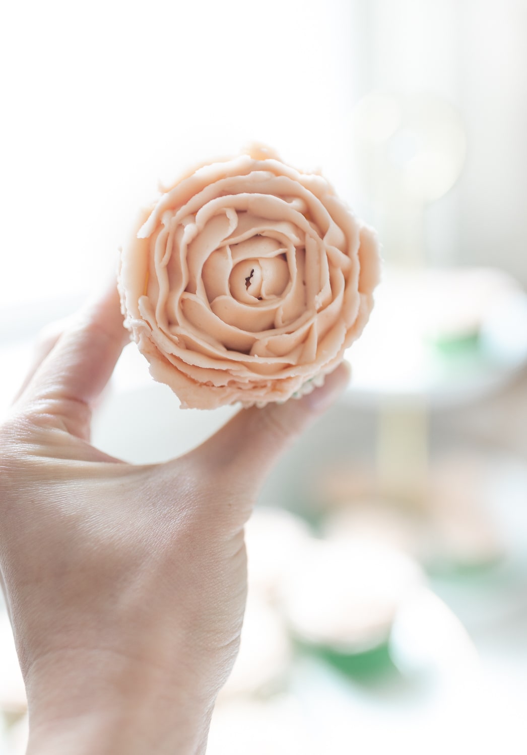 Pink buttercream roses piped onto a mint julep cupcake baked by blogger Stephanie Ziajka on Diary of a Debutante