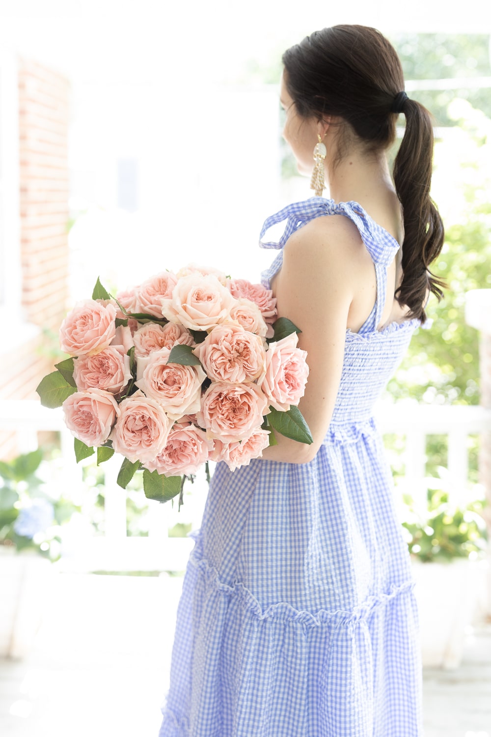 Blogger Stephanie Ziajka holding pink garden roses from Grace Rose Farm on Diary of a Debutante